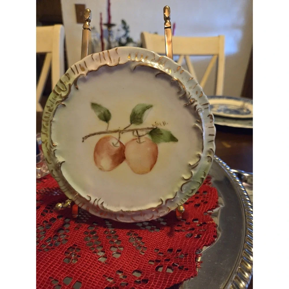 vintage hand-painted decorative porcelain plate with a fluted, gold-trimmed...